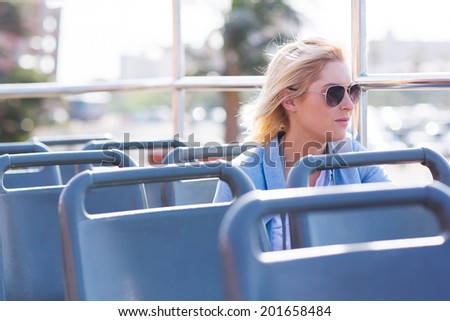 thoughtful young woman on an open top bus