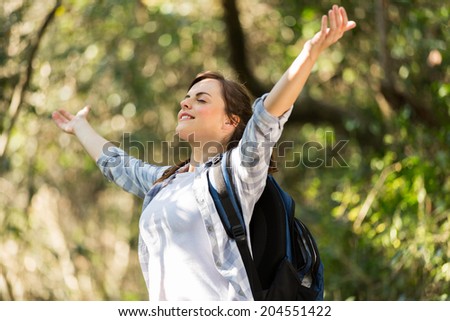 happy young woman taking deep breath in the jungle