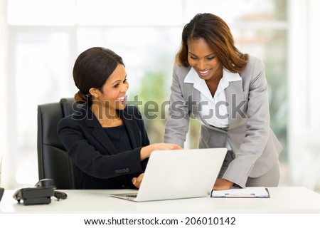 two african business women working at the office on a computer