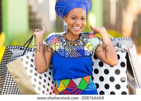 portrait of attractive black woman carrying shopping bags