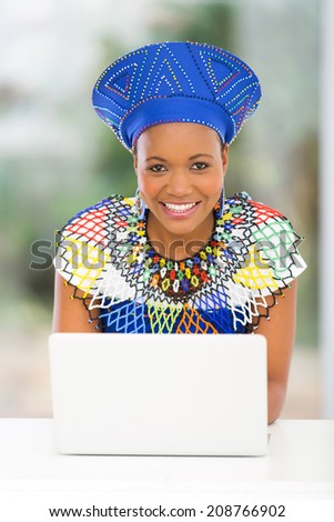 pretty south african woman using laptop computer at home