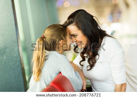 lovely mother and daughter playing at airport while waiting for their flight