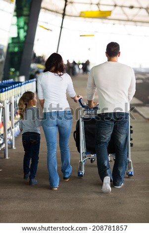 back view of young family at airport