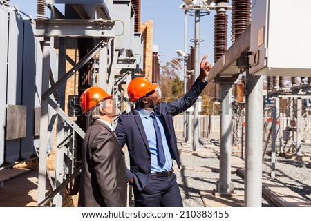 professional managers inspecting electricity power plant
