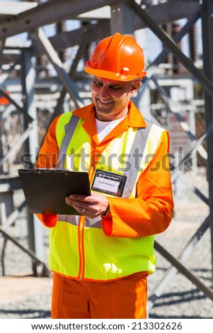 senior industrial technician taking readings in power plant