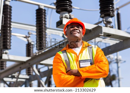 african electrical engineer with arms crossed in electricity power plant