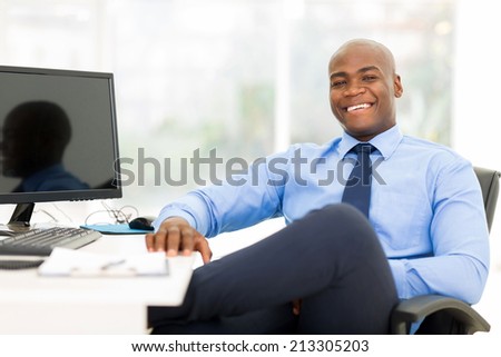 relaxed black businessman sitting in modern office