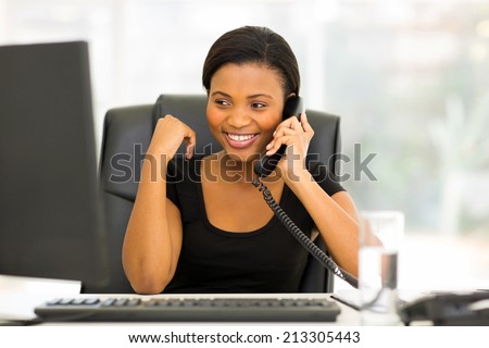 attractive african office worker talking on the phone