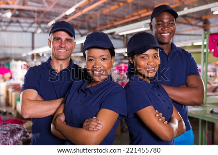 happy textile factory co-workers with arms crossed