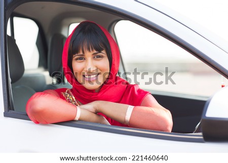 beautiful indian woman inside her new car