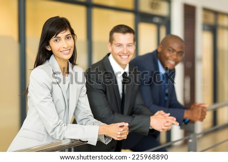 portrait of pretty indian business woman with co-workers