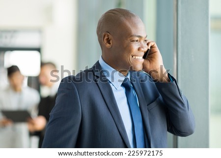 handsome african american business executive talking on cell phone