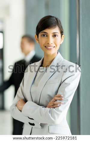 pretty indian business woman with arms crossed