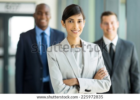 beautiful female business leader with team standing on background