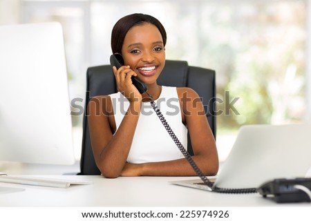 beautiful african office worker talking on telephone