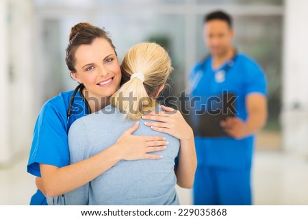 caring young medical doctor hugging patient