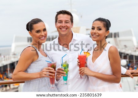 group of friends drinking cocktails on cruise ship