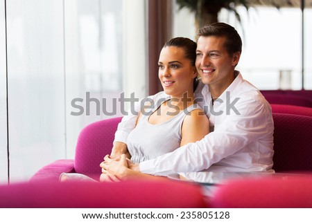 cute young couple sitting in coffee shop