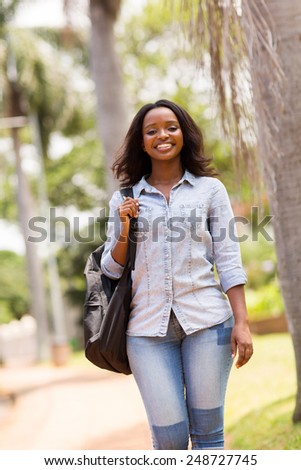 gorgeous young african college student walking on campus