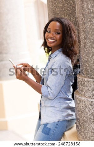 happy female african uni student using smart phone
