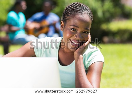 beautiful african university student with a computer