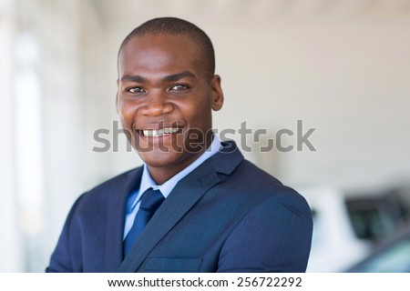 close up portrait of african america businessman at car dealership