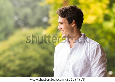 cheerful young man standing outdoors