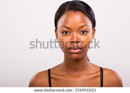 cute african american girl without makeup on plain background