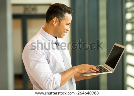 modern middle aged business man looking at computer screen