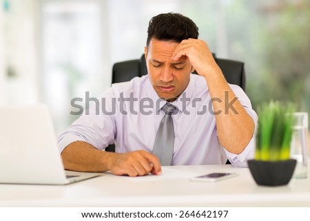 stressed businessman having headache at work