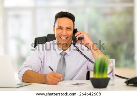good looking mid age businessman making phone call