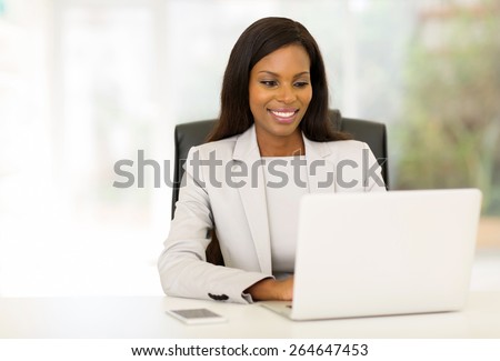 happy afro american businesswoman using computer in office