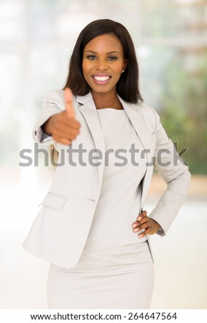 happy african business woman giving thumb up in office