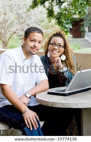 two african college students study computer together
