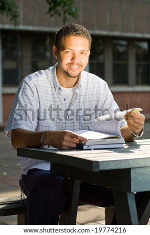 male university student study books outdoor