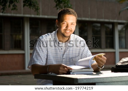 male university student study books outdoor