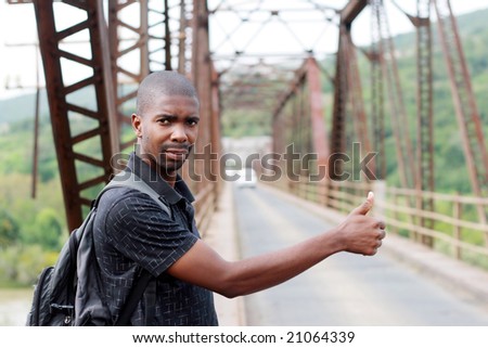 african young man hitchhiking
