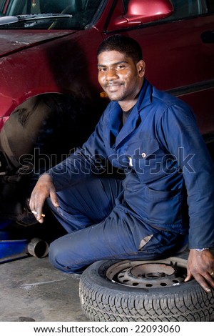 indian mechanic changing vehicle tire