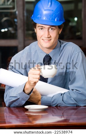 A handsome business construction manager in a cafe