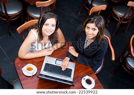 Overhead view of two business women meeting in a cafe