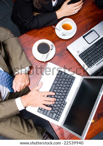 Overhead view of two business people meeting in a cafe