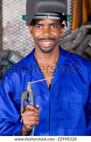 african male welder with welding equipment