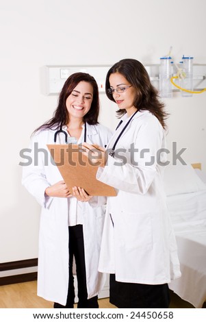 two doctors looking at medical report in the ward