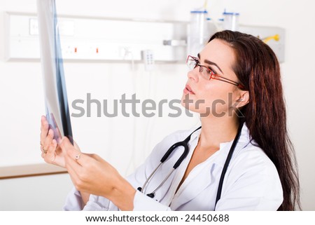 female doctor studying patient\'s x-ray film