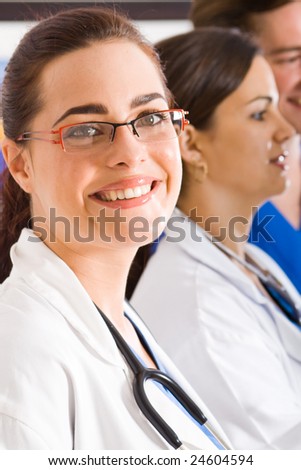 female doctor portrait with colleagues