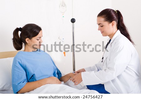 young doctor helping her patient with I.V drips