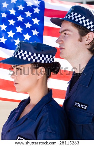 two police officer standing in front of american flag