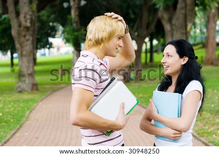 young university students chatting in campus outdoors