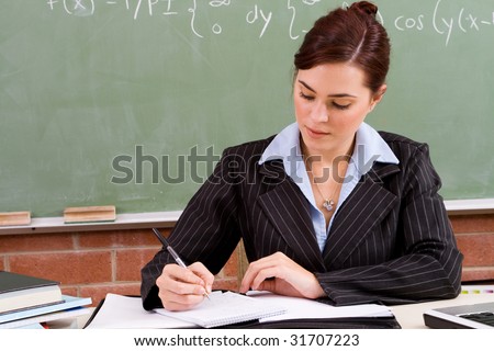beautiful female school teacher preparing for the class