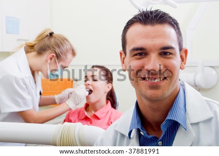 friendly male dentist in his practice